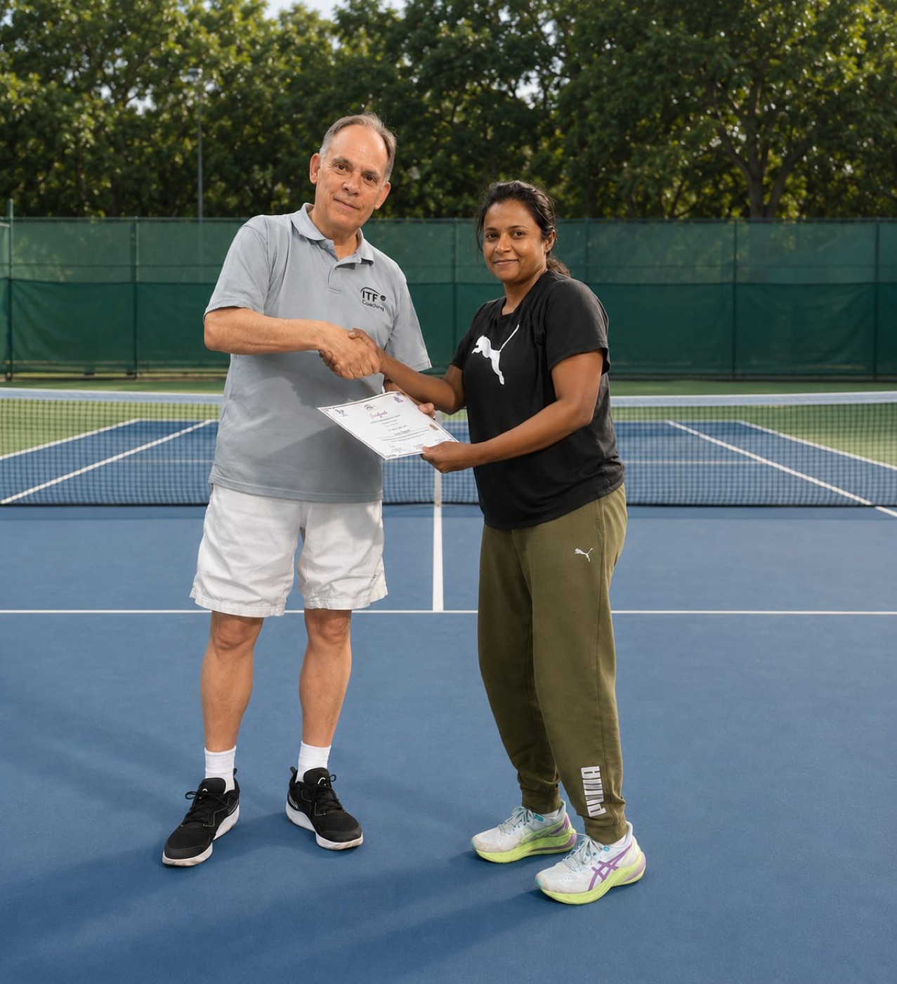 Deepa Engade receiving ITF coaching certification from Miguel Crespo, Head of Participation & Education at the International Tennis Federation